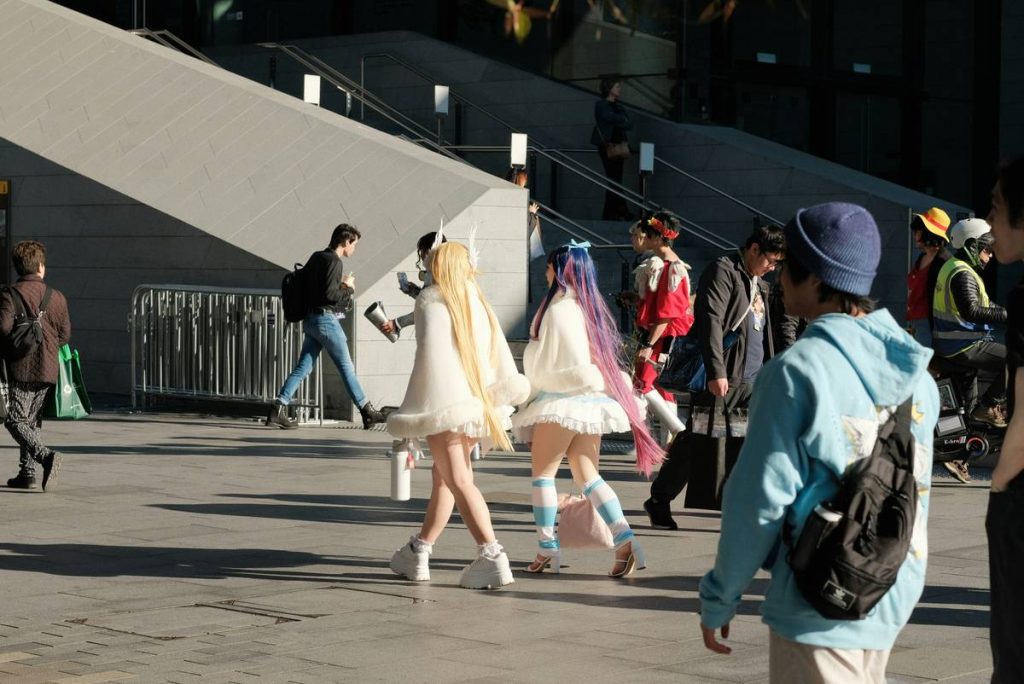 A group of people walking down a street