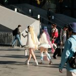 A group of people walking down a street